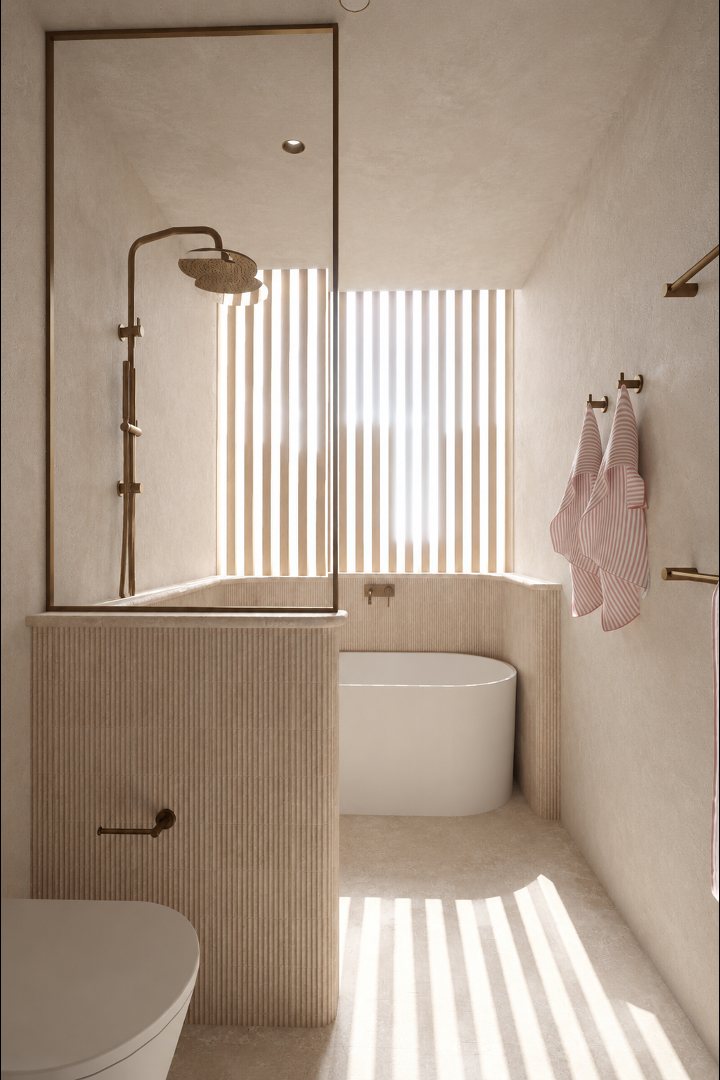 Bath and shower behind a fluted travertine half wall, lit through timber battens