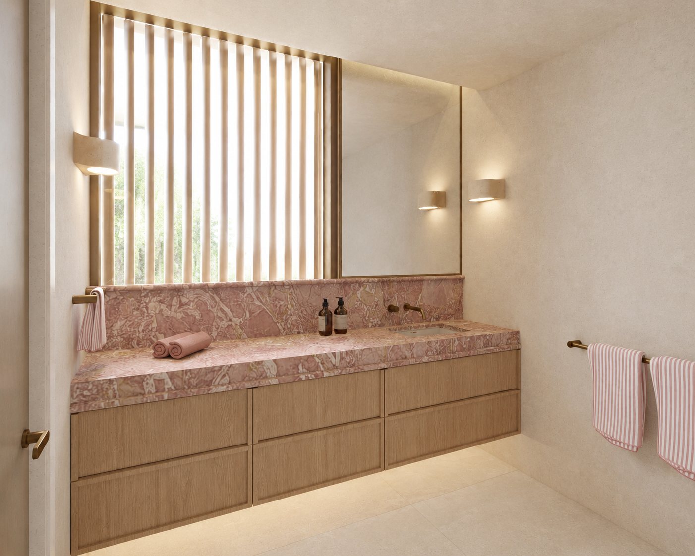 Oak vanity with a rosso marble top and towel rail, lit by wall sconces