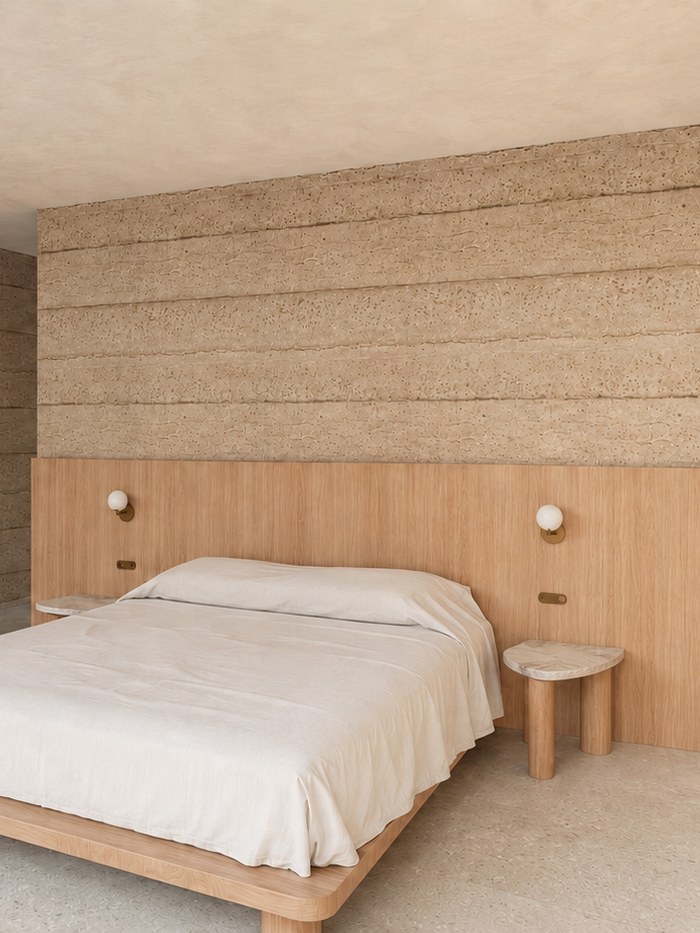 Bedroom with rammed earth walls, oak joinery and terrazzo floor, Clunes Residence