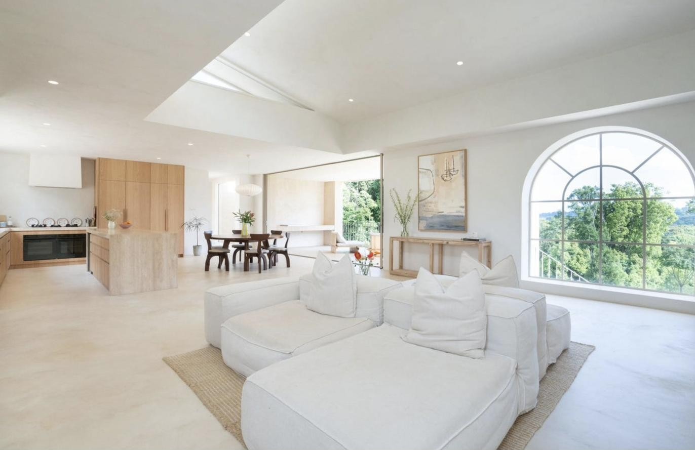 Living room with white sofa and forest views, Komorebi Home