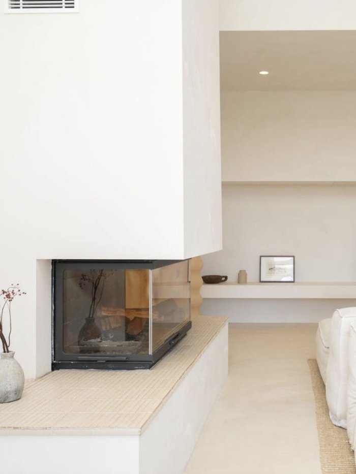 Living space with a two-sided fireplace and artwork, Komorebi Home