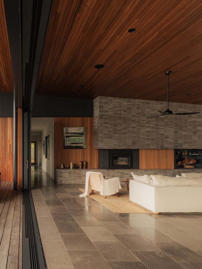 Indoor-outdoor living space opening onto a timber deck, Newrybar Residence