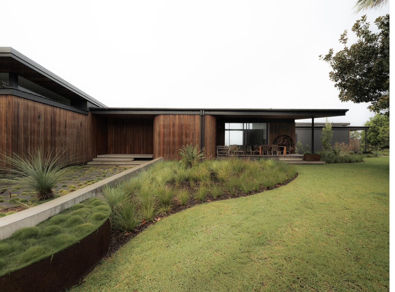 Side exterior with deck and native grasses, Newrybar Residence