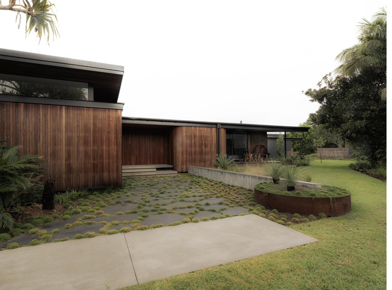 Exterior pathway alongside the timber-clad residence, Newrybar Residence